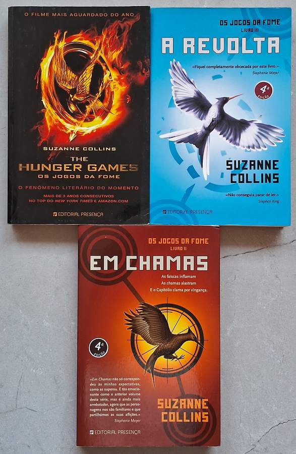 Trilogia Os Jogos da Fome, de Suzanne Collins, completa com os volumes Os Jogos da Fome, Em Chamas e A Revolta, da Editorial Presença.